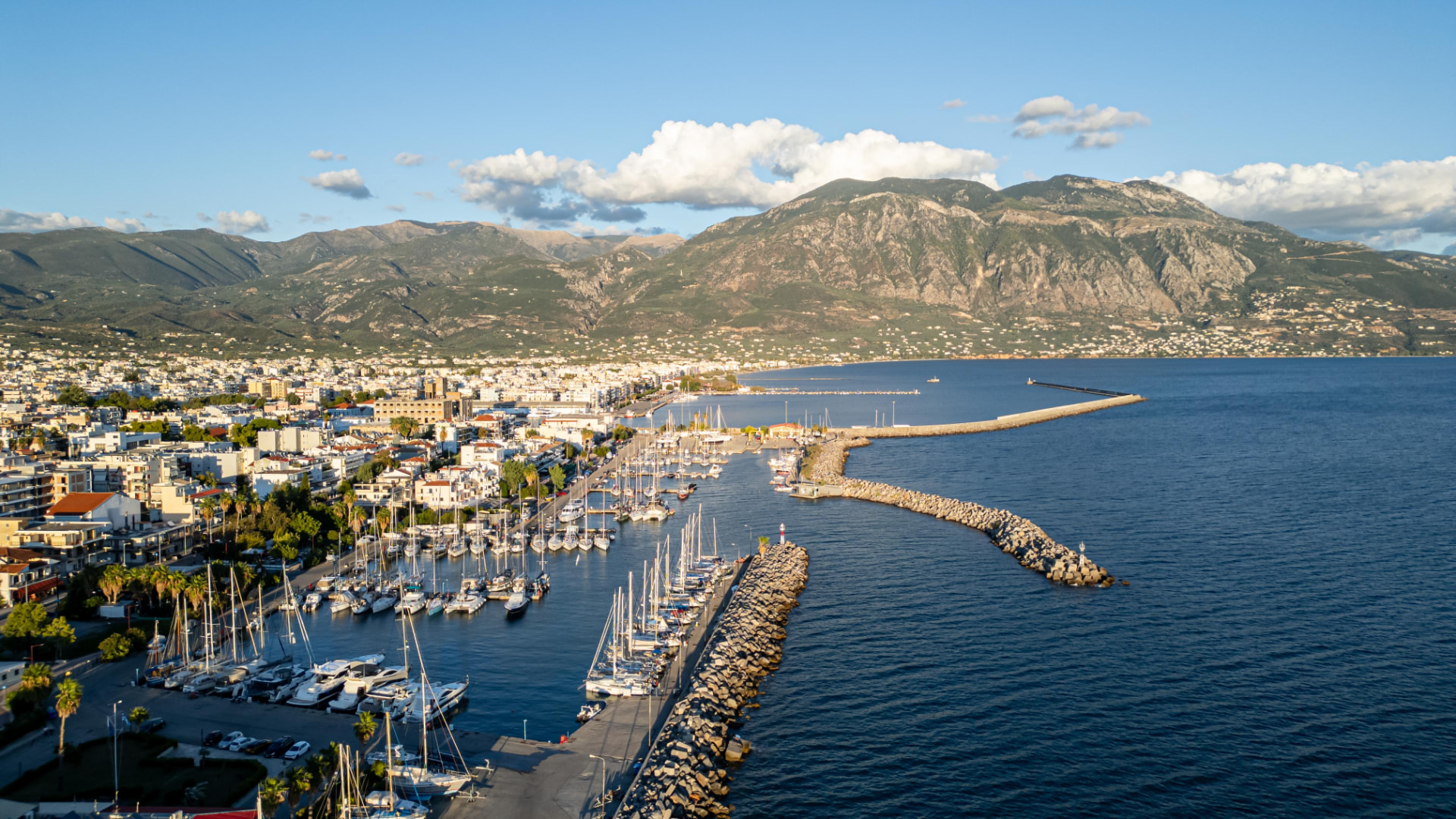 Sailing boats in Kalamata harbour with mountains in the background
