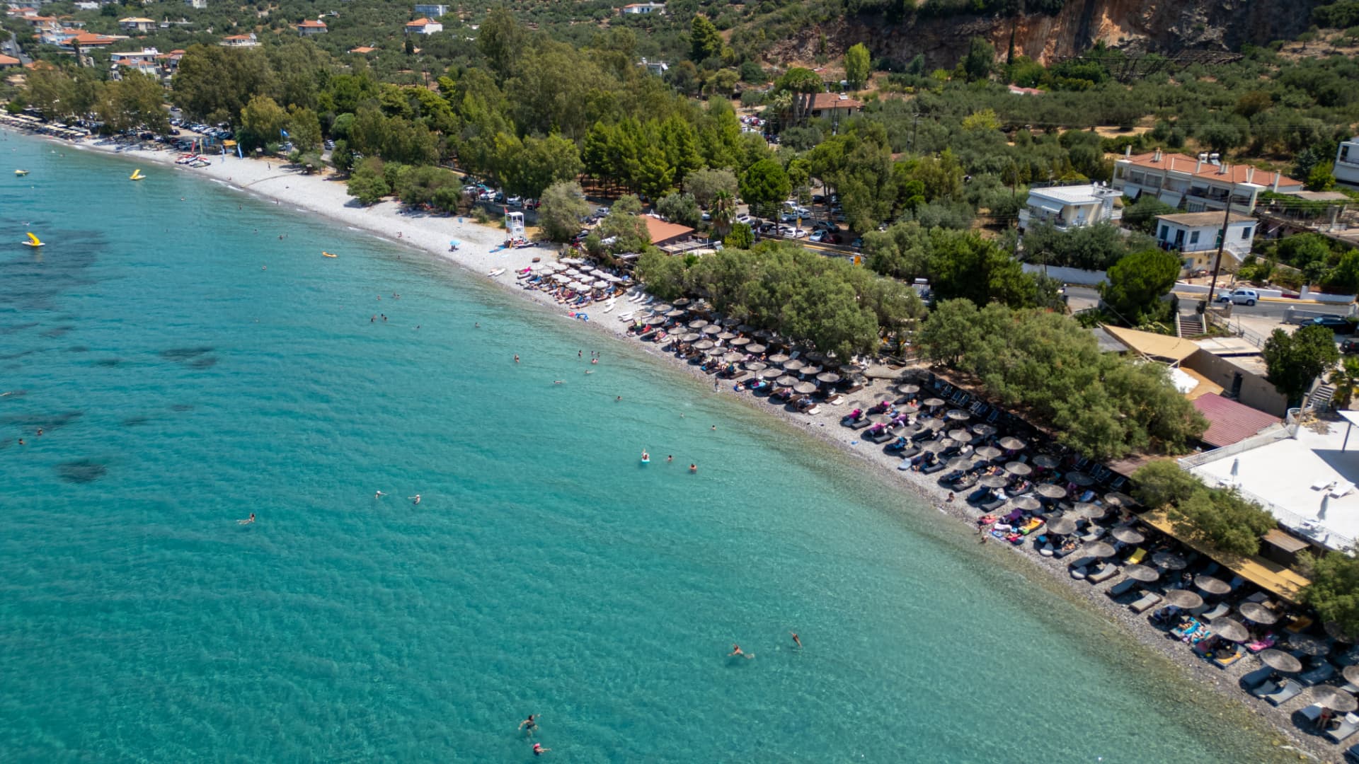 Turquoise sea and beach with umbrellas near Kalamata, Greece