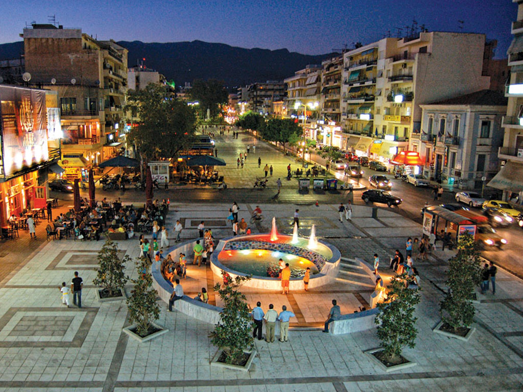 Central square of Kalamata with fountains and people in the evening